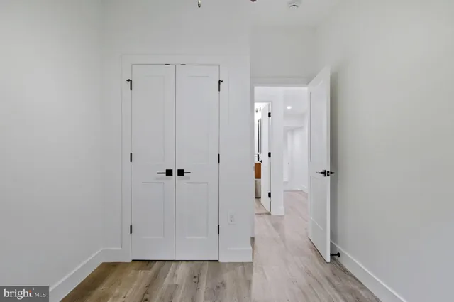 a view of room with ceiling fan and window