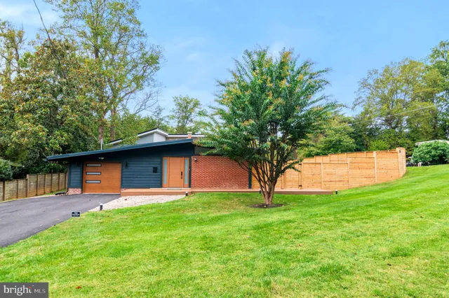 a view of a backyard with a garden and entertaining space