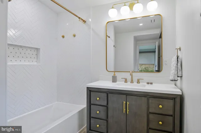 a bathroom with a bath tub with shower