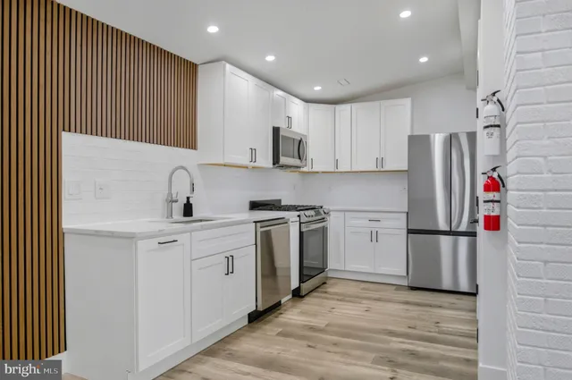 a kitchen with stainless steel appliances granite countertop a refrigerator sink and cabinets