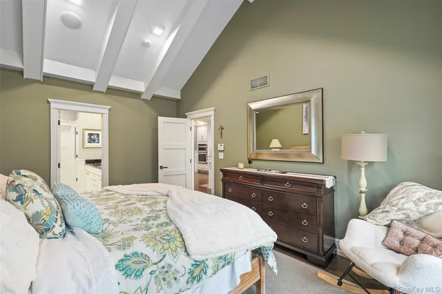 a bedroom with a bed and a dresser in it