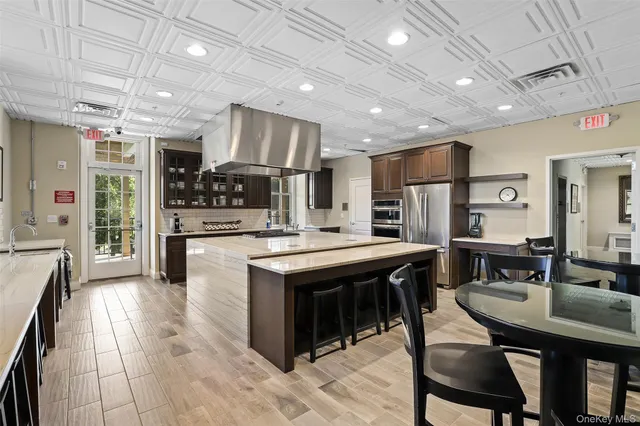 a living room with furniture a wooden floor and a chandelier