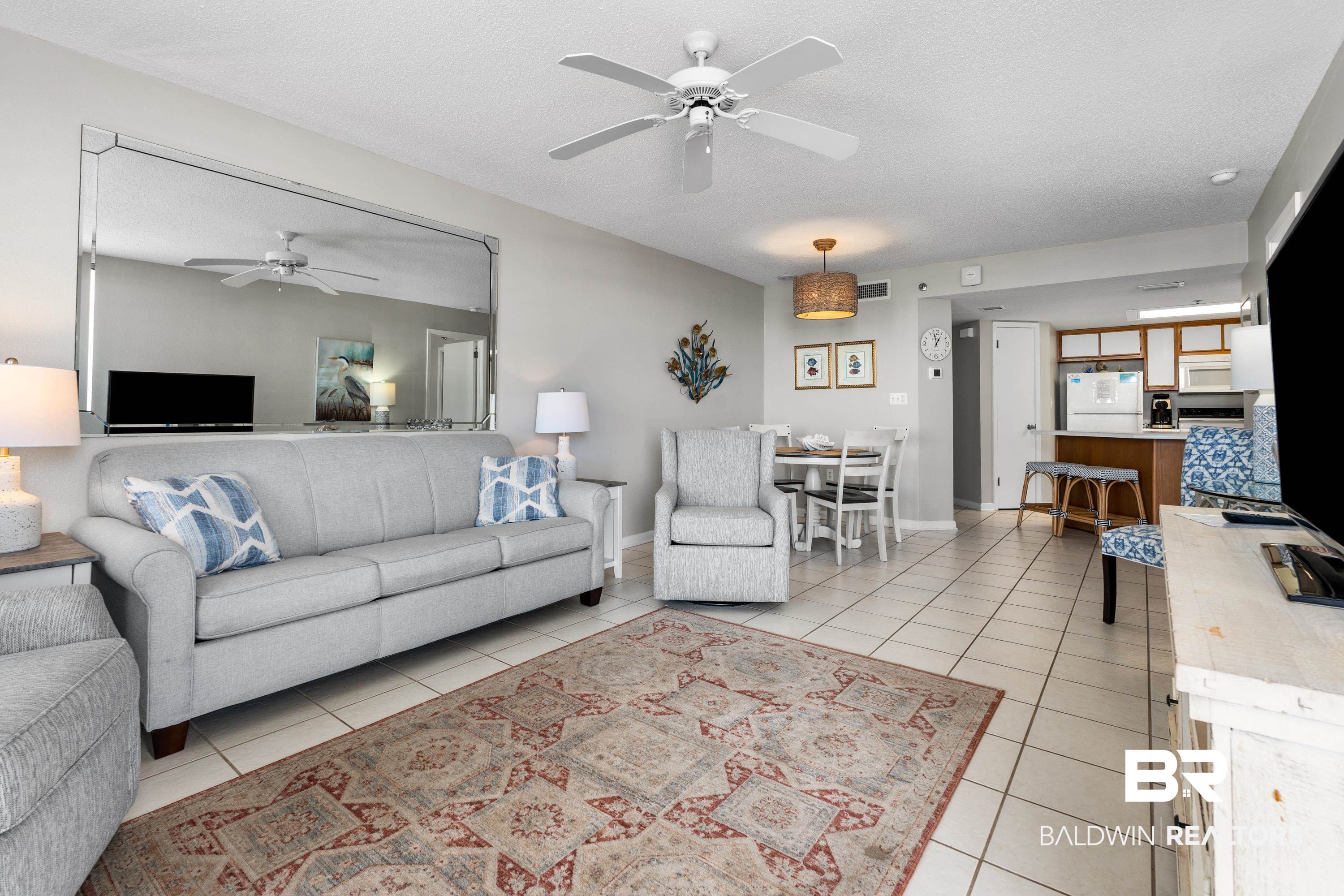 26802 Perdido Beach Boulevard, Unit 406 Orange Beach, AL 36561 - Photo 6 of 37 Living area featuring a ceiling fan and a textured ceiling