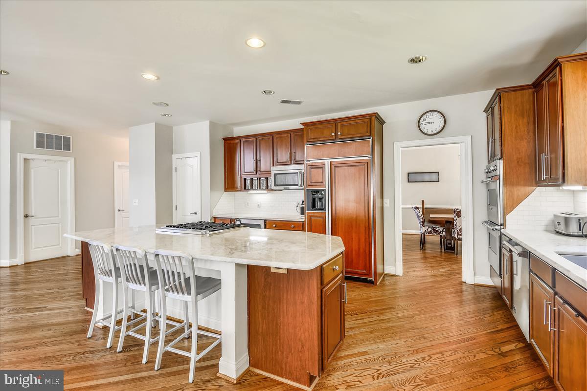 92 Colony Crossing Edgewater, MD 21037 - Photo 9 of 48 With cherry cabinets and quartzite counters