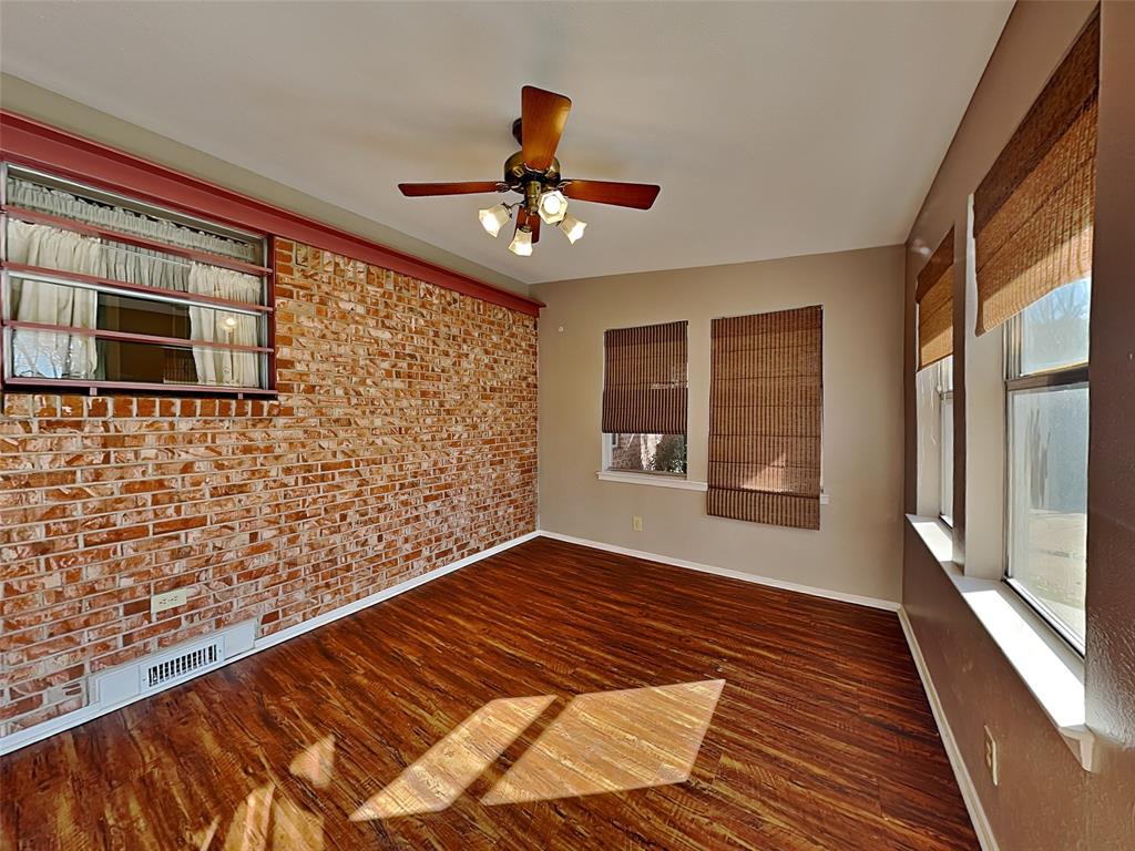 13630 Willow Bend Road Dallas, TX 75240 - Photo 16 of 17 a view of an empty room with a window and wooden floor