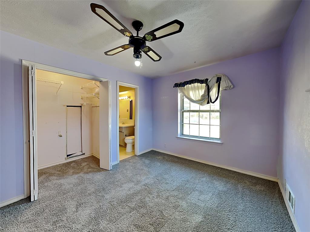 13630 Willow Bend Road Dallas, TX 75240 - Photo 10 of 17 an empty room with ceiling fan and windows