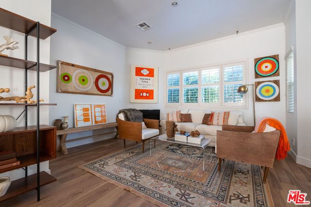 a living room with furniture and next to a window