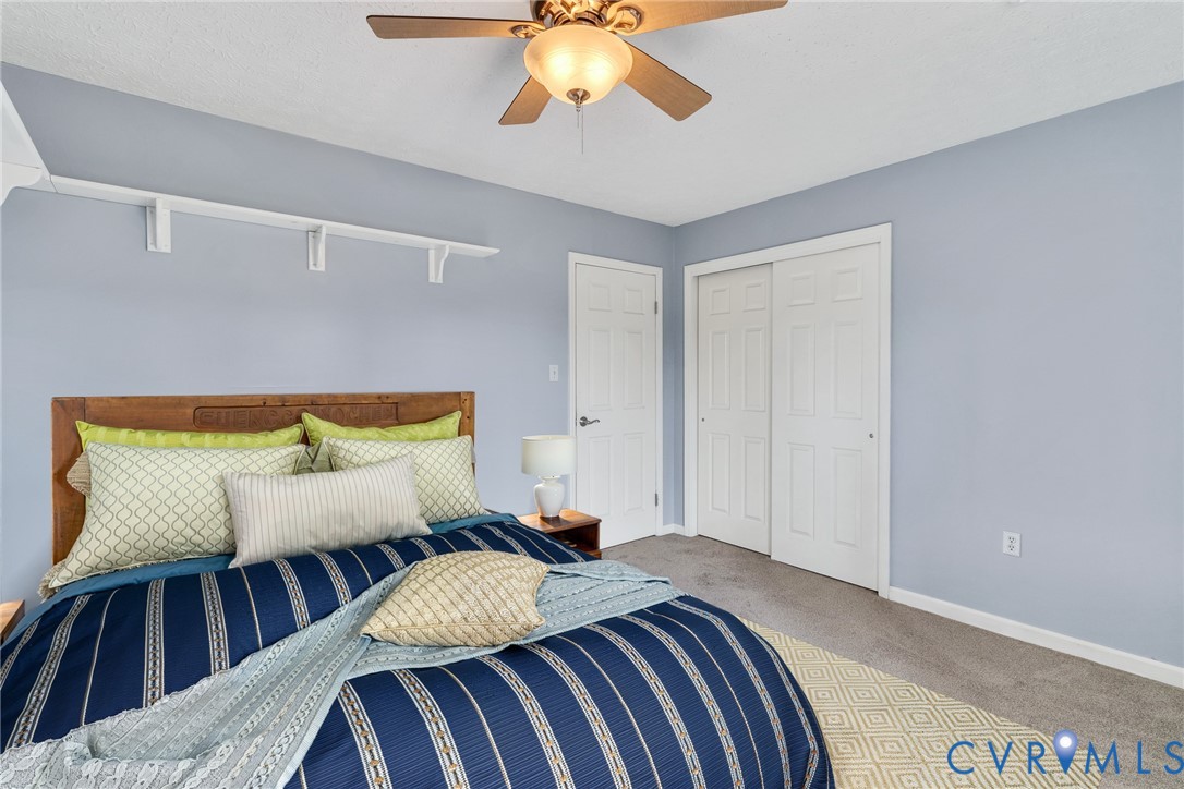 9829 Line Fence Road Hayes, VA 23072 - Photo 22 of 64 a bedroom with a bed and a lamp