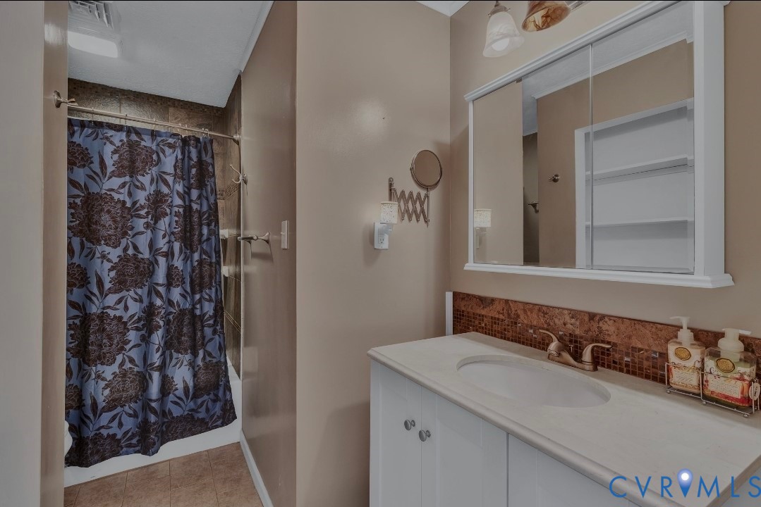 9829 Line Fence Road Hayes, VA 23072 - Photo 25 of 64 a bathroom with a sink and a mirror