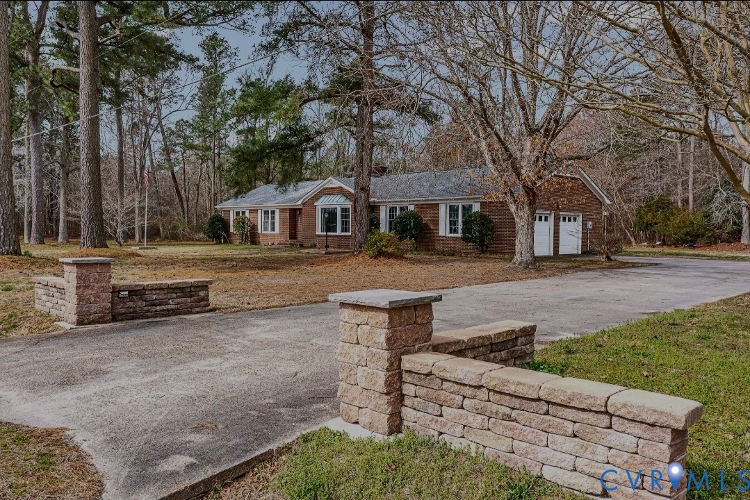 9829 Line Fence Road Hayes, VA 23072 - Photo 62 of 64 a front view of a house with a yard covered with snow and trees