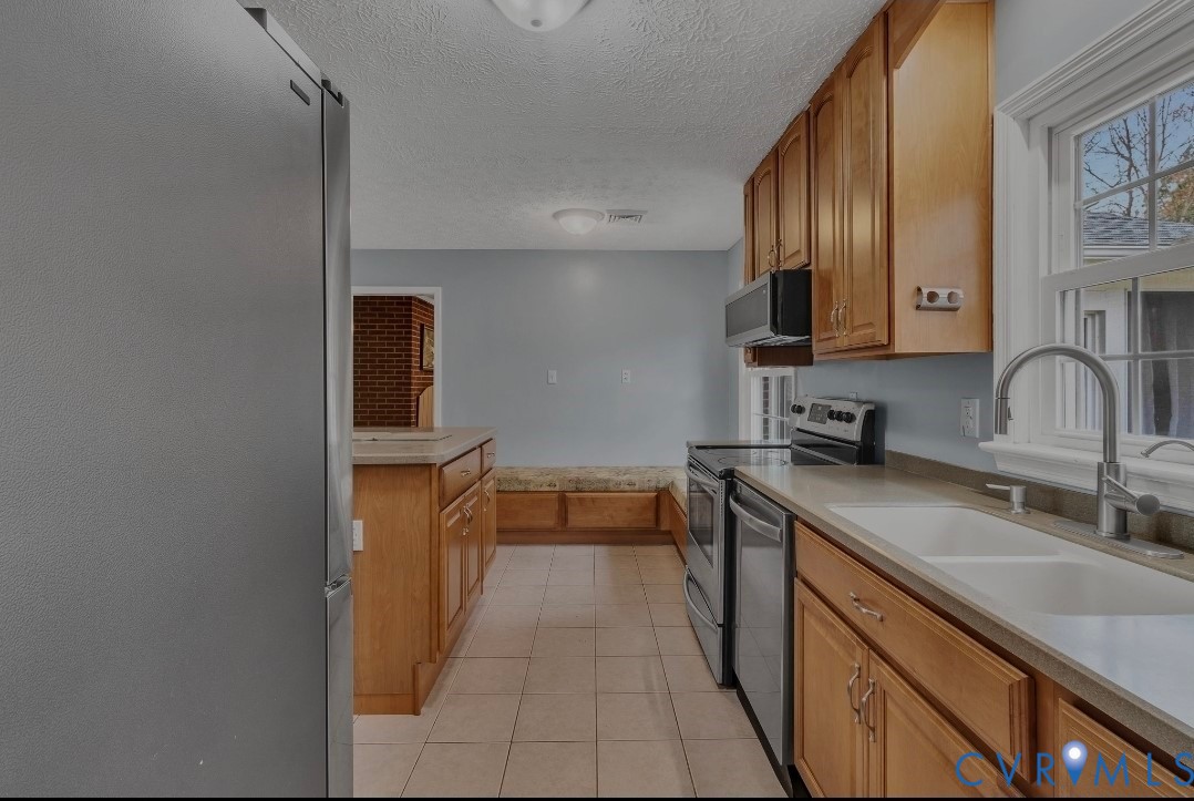 9829 Line Fence Road Hayes, VA 23072 - Photo 7 of 64 a kitchen with a sink and a stove top oven