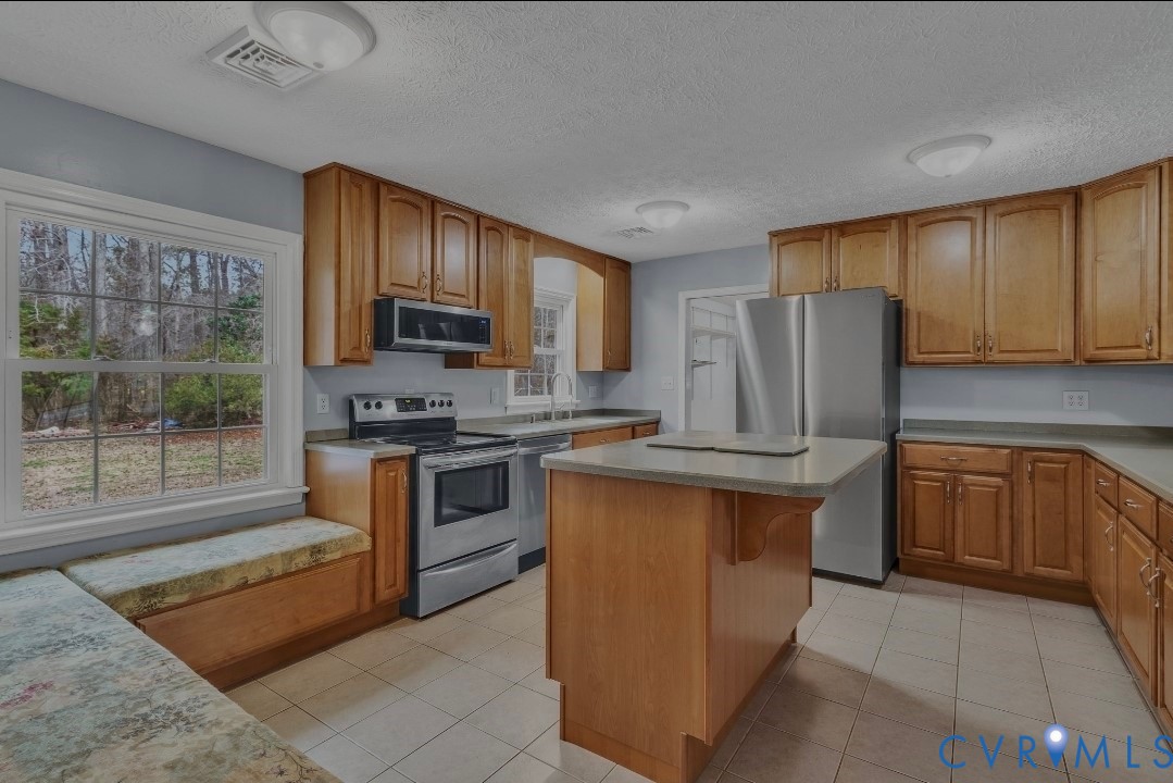 9829 Line Fence Road Hayes, VA 23072 - Photo 9 of 64 a kitchen with stainless steel appliances granite countertop a refrigerator stove top oven and sink