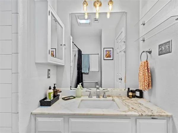 a bathroom with double vanity sinks and a mirror