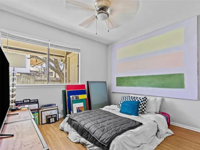 a bedroom with a bed and a dresser next to a window