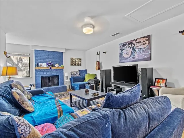 a living room with fireplace furniture and a flat screen tv