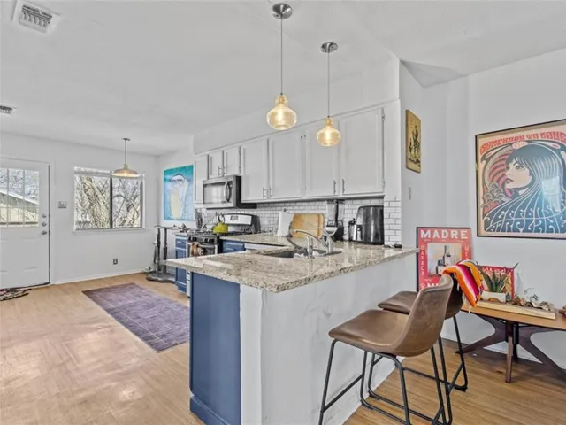 a open kitchen with a table and chairs in it