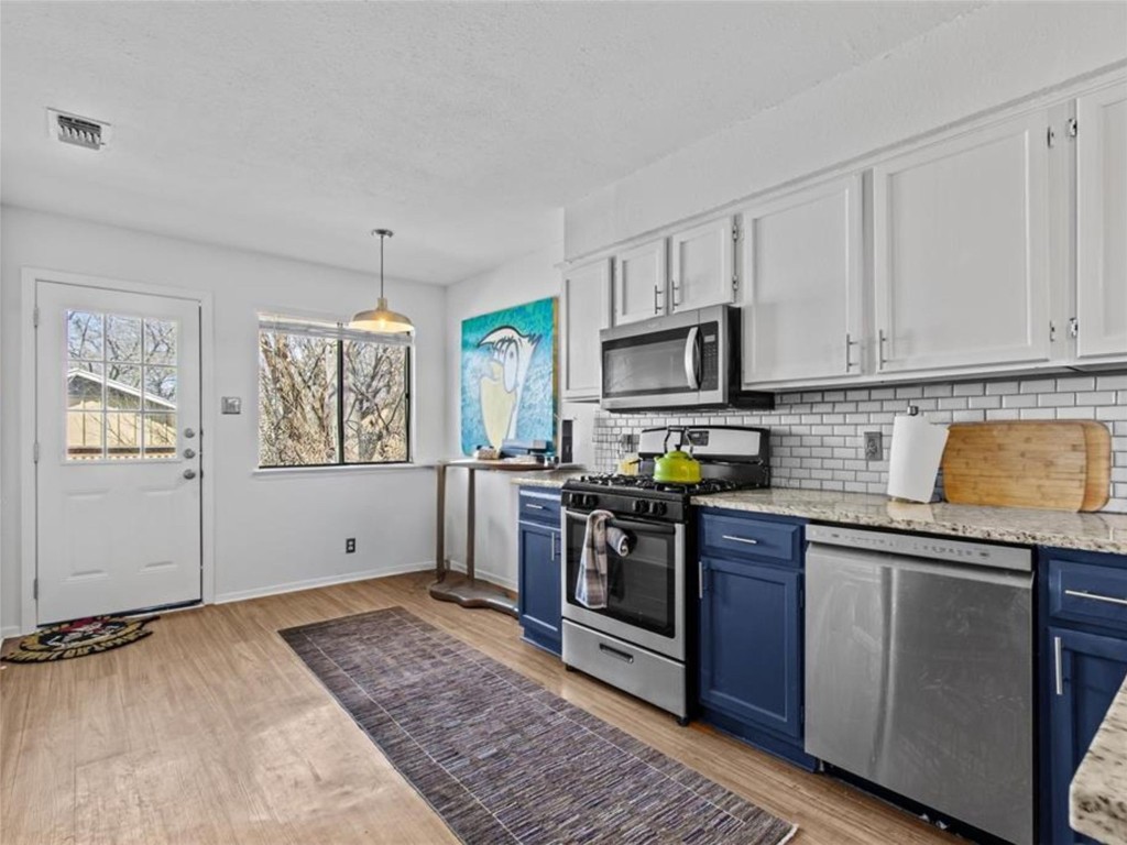 2800 Burleson Road Austin, TX 78741 - Photo 23 of 35 a kitchen with stainless steel appliances granite countertop a stove a sink and a granite counter tops