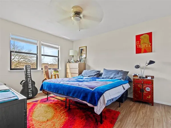 a bedroom with a bed and wooden floor