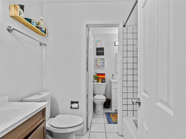 a white toilet sitting next to a bathroom sink