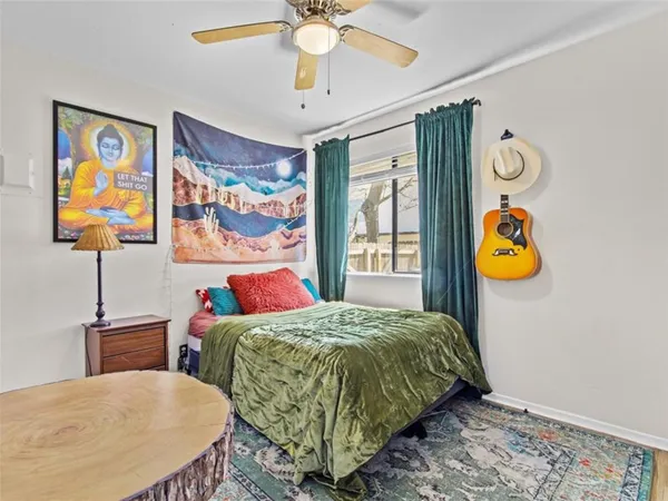 a bedroom with a bed and painting on the wall