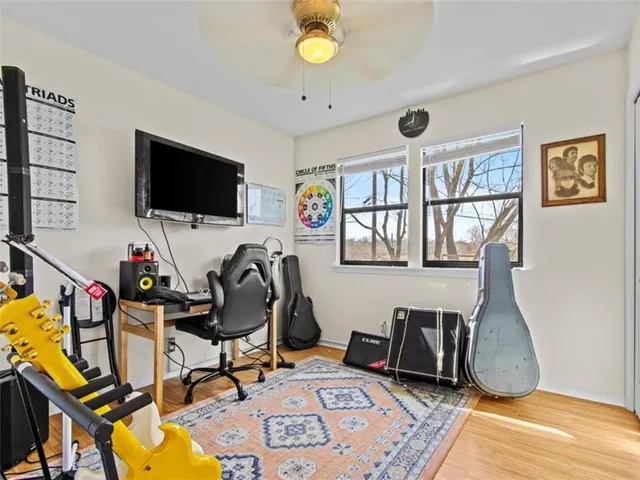 a view of a workspace with furniture and a flat screen tv