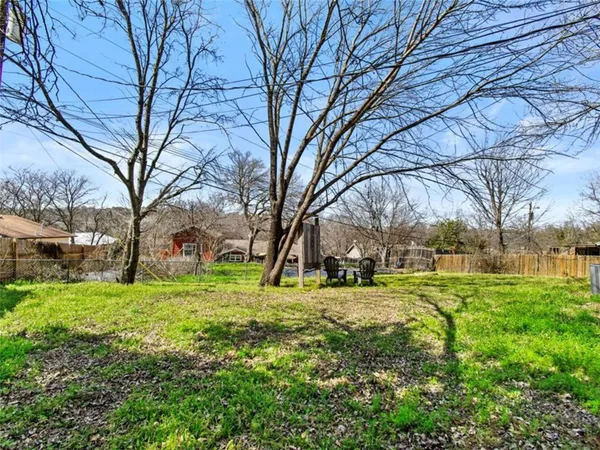 a view of a yard with a tree