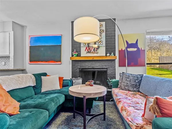 a living room with furniture a rug and a fireplace