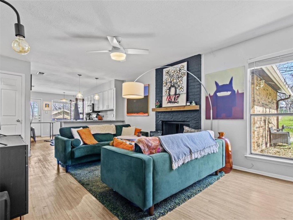 2800 Burleson Road Austin, TX 78741 - Photo 7 of 35 a living room with fireplace furniture and a large window