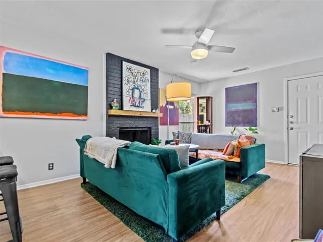 a living room with fireplace furniture and a flat screen tv