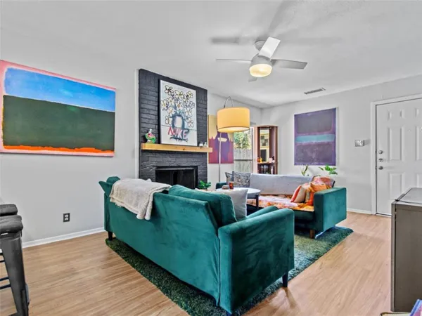 a living room with fireplace furniture and a flat screen tv