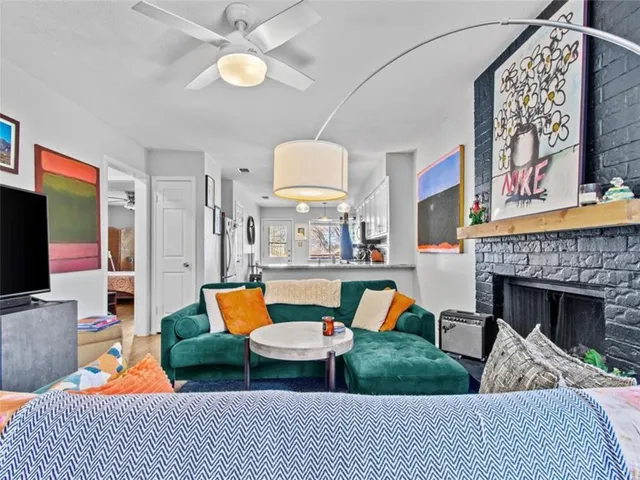 a living room with furniture a fireplace and a flat screen tv