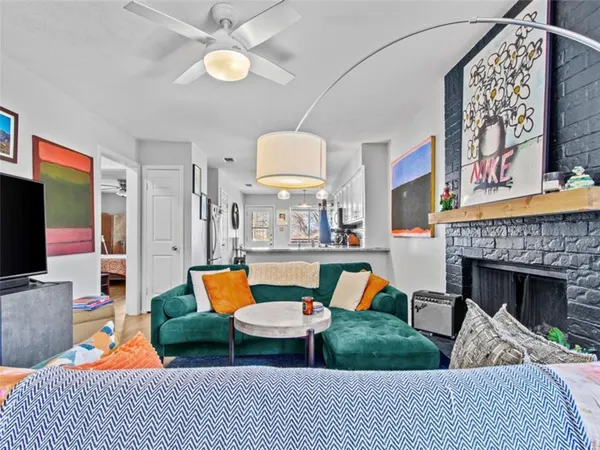 a living room with furniture a fireplace and a flat screen tv