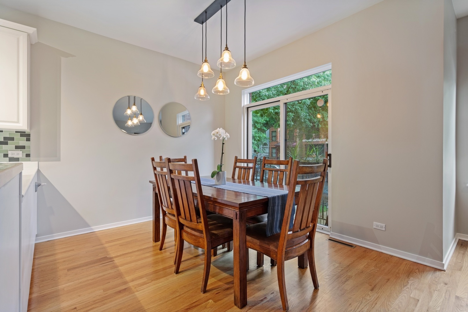 2955 North Racine Avenue, Unit 1A Chicago, IL 60657 - Photo 8 of 29 a dining room with wooden floor a chandelier a wooden table and chairs