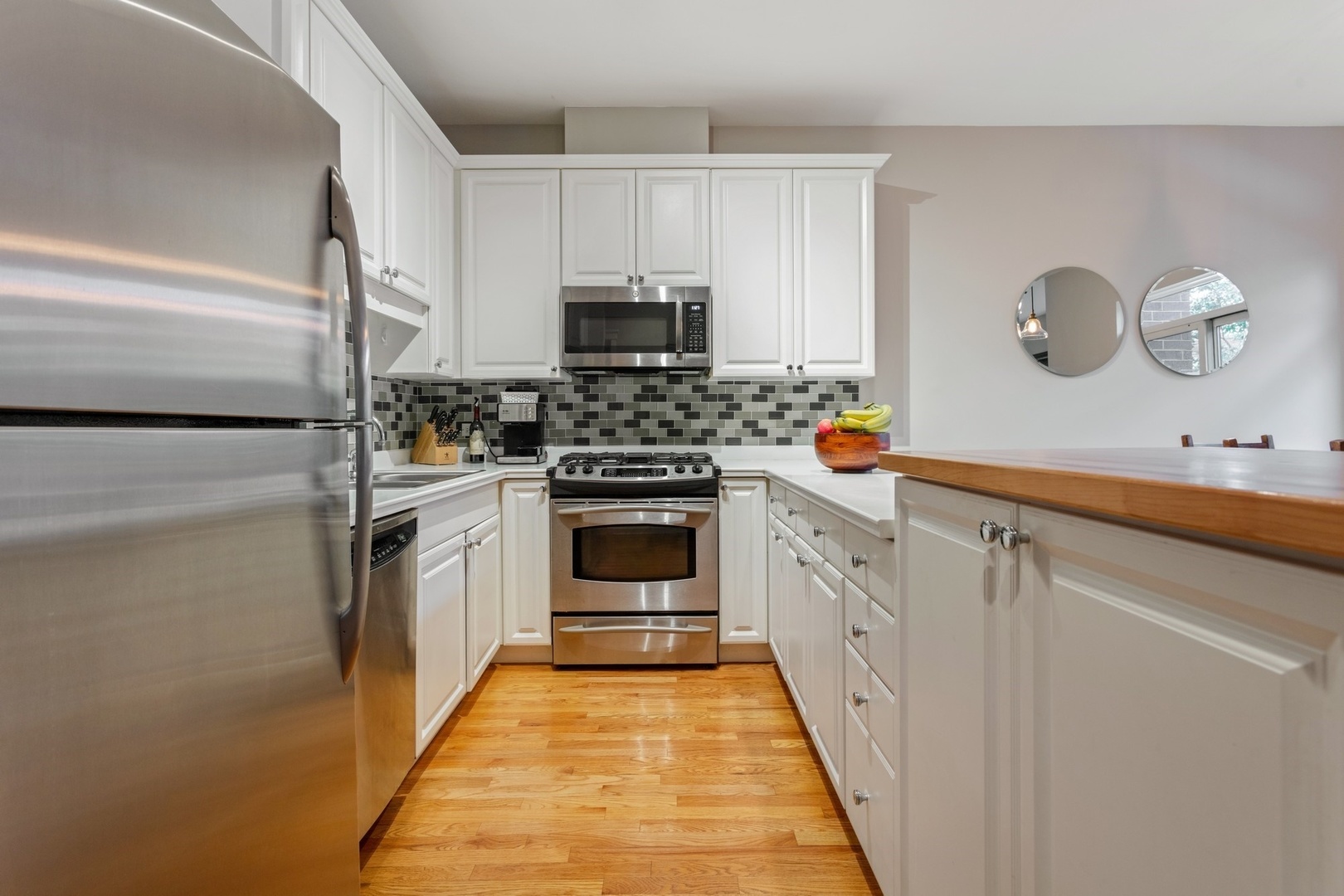 2955 North Racine Avenue, Unit 1A Chicago, IL 60657 - Photo 9 of 29 a kitchen with white cabinets and white appliances