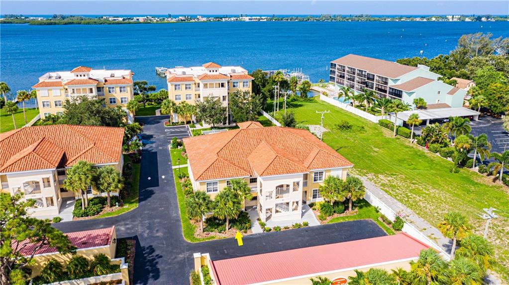 1112 South McCall Road, Unit 312 Englewood, FL 34223 - Photo 1 of 1 an aerial view of residential houses with outdoor space and swimming pool