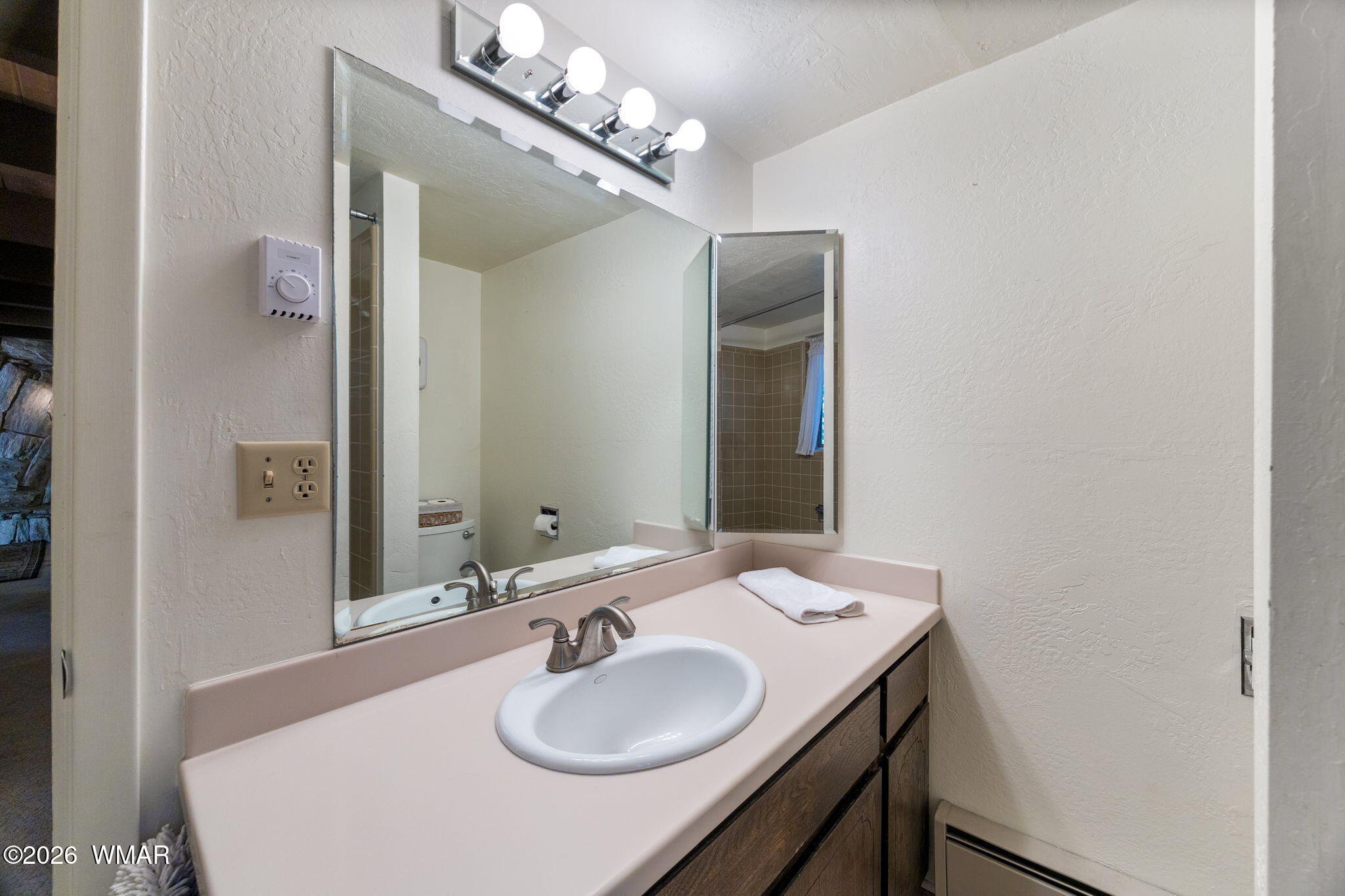 7456 Geronimo Road Pinetop, AZ 85935 - Photo 14 of 35 a bathroom with a sink and a mirror