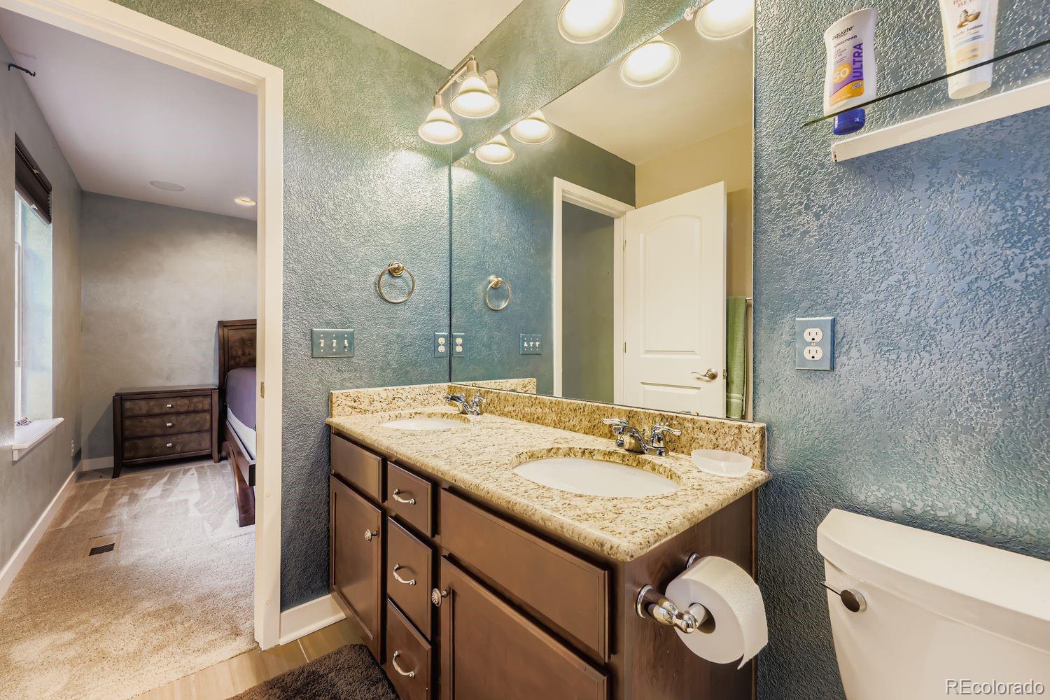 8508 Redpoint Way Broomfield, CO 80021 - Photo 12 of 21 a bathroom with a granite countertop sink and a mirror
