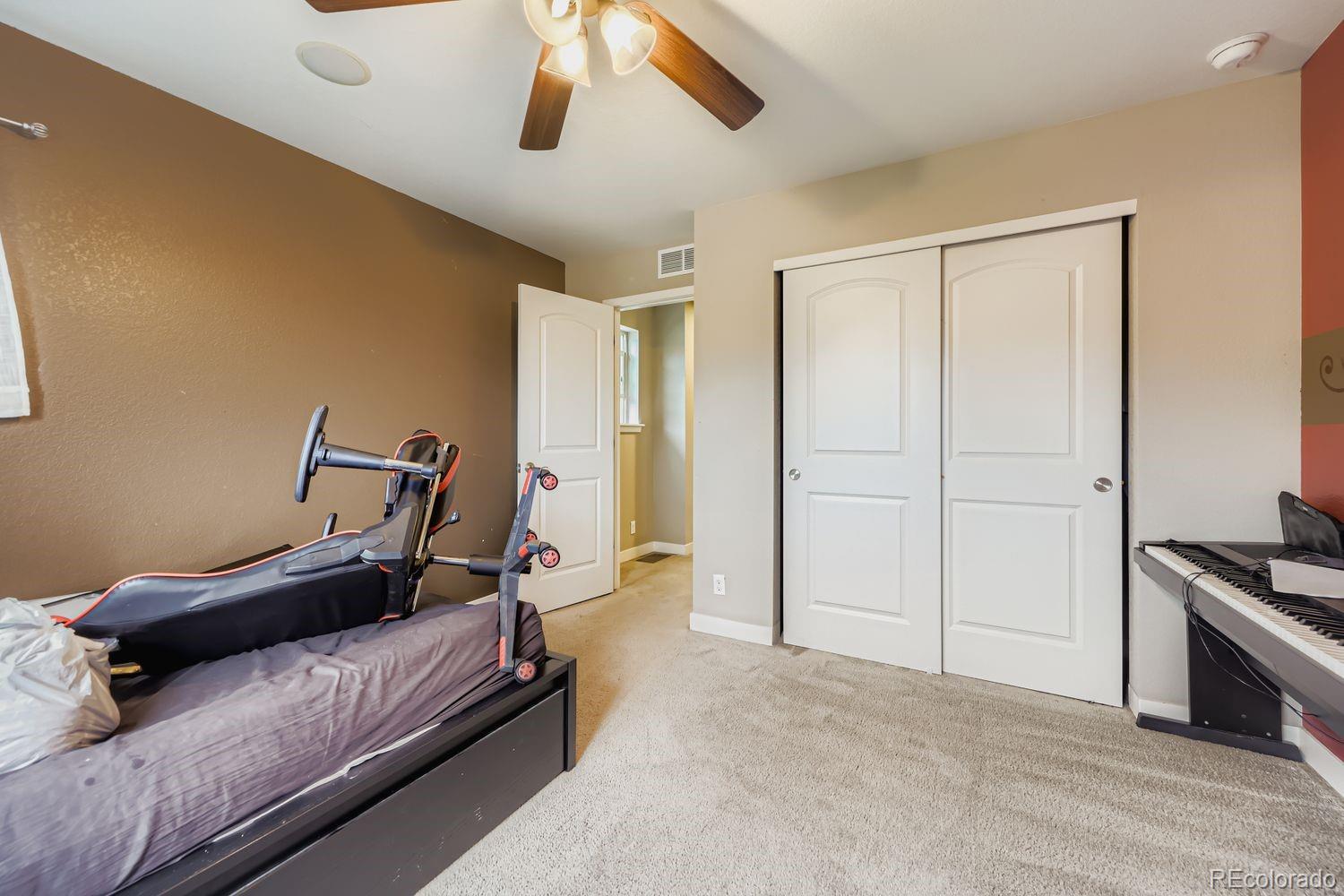 8508 Redpoint Way Broomfield, CO 80021 - Photo 15 of 21 a bedroom with a bed and wooden floor