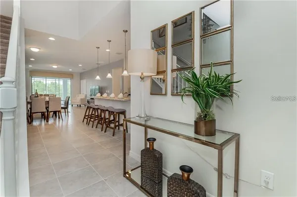a hallway with a potted plant on a table and a potted plant