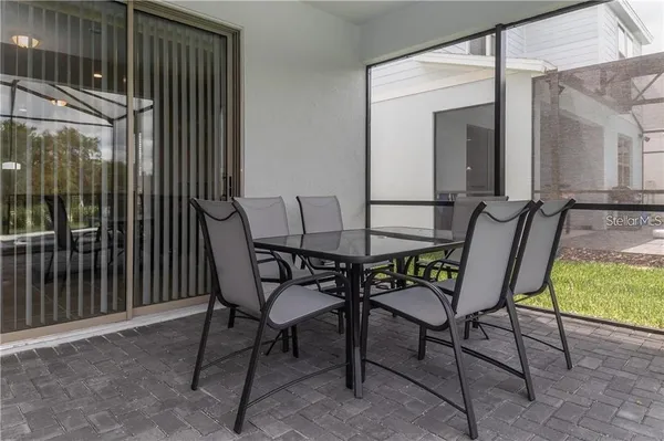 a view of a chairs and table in the balcony