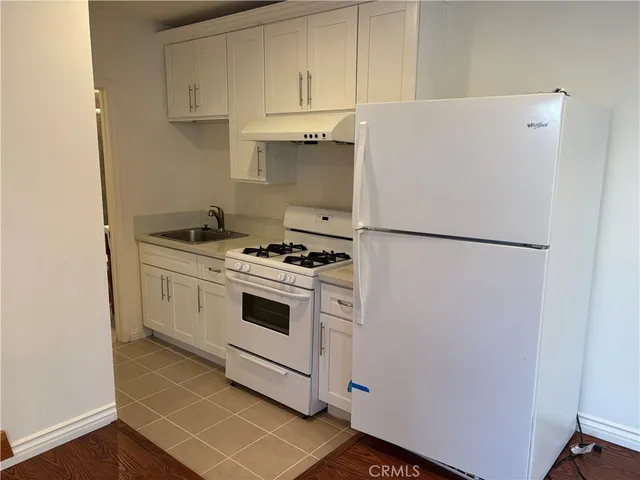 a white refrigerator freezer sitting inside of a kitchen