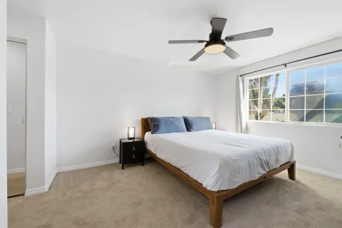 a bedroom with a bed and window