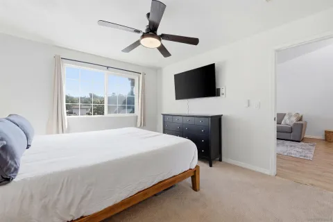 a bedroom with a bed and a flat screen tv
