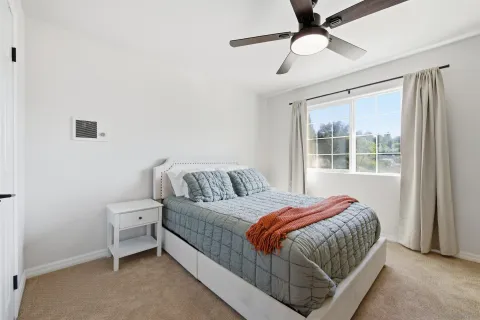 a bedroom with a bed and window