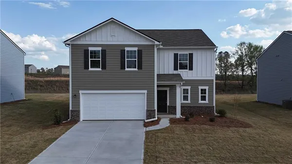 a kitchen with stainless steel appliances granite countertop a refrigerator a stove a sink a microwave and a refrigerator