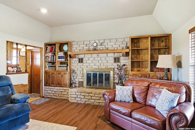 a living room with furniture fireplace and window