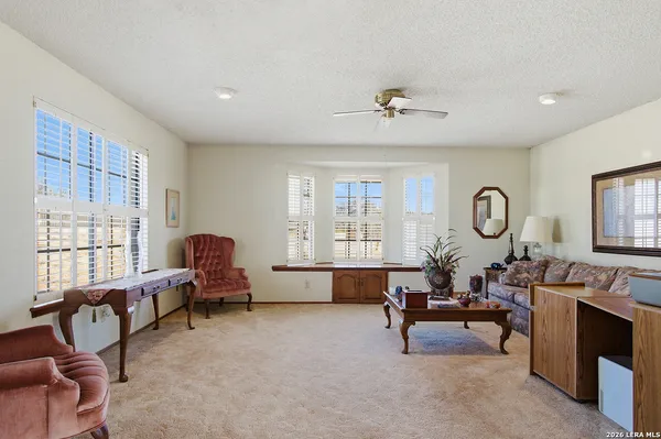 a living room with furniture chandelier and a window