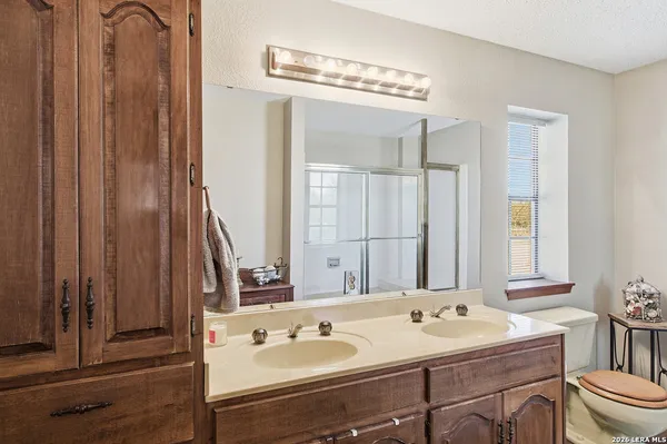 a bathroom with a double vanity sink and a mirror