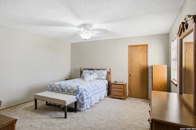 a bedroom with a bed and a table in it