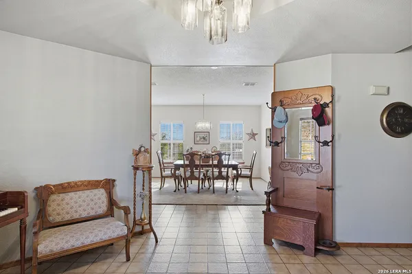 a living room with furniture and a dining table with kitchen view